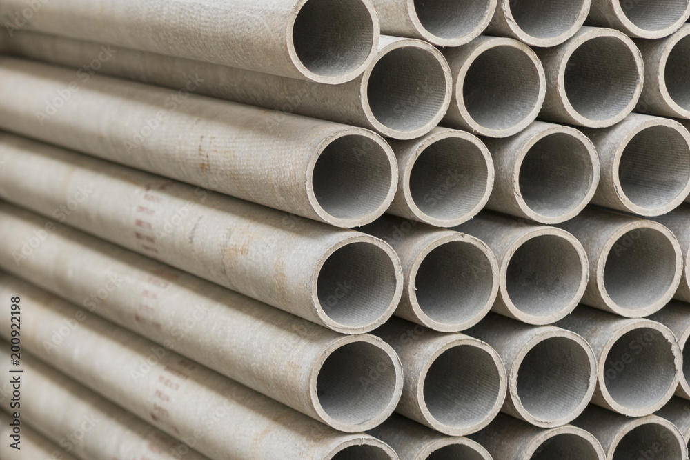 asbestos pipes in a stack in a warehouse or in a building store asbestos pipes in a stack in a warehouse or in a building store
