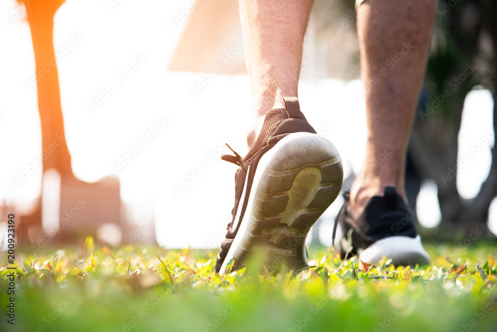 Sport man warm up to jogging at park. Exercise and Outdoors concept.  Healthy activity and Lifestyle theme. Stock Photo | Adobe Stock