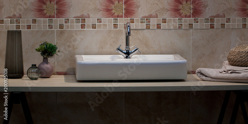 Bilde på lerret sink with a faucet, a towel and a vase in a cozy and stylish bathroom
