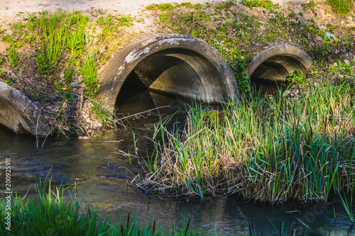 Fotografie Concrete culvert pipe hole system draining sewage water