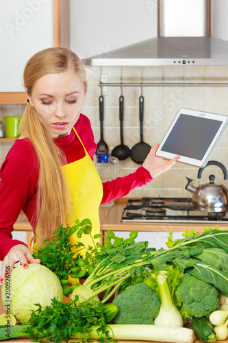 Woman having green vegetables thinking about cooking