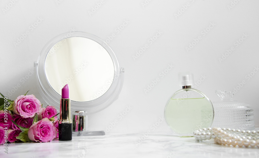 women's accessories on table in the bathroom with a mirror and cosmetics