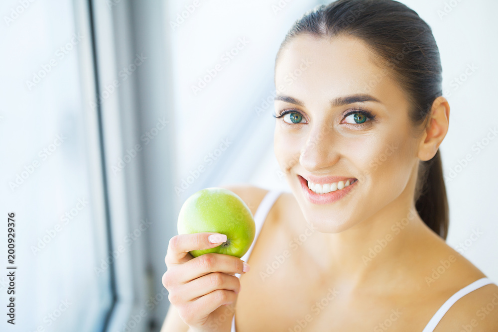 Woman Eating Apple. Beautiful Girl With White Teeth Biting Apple. High Resolution Image Woman Eating Apple. Beautiful Girl With White Teeth Biting Apple. High Resolution Image