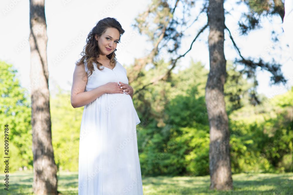Pregnant woman in a spring park Pregnant woman in a spring park