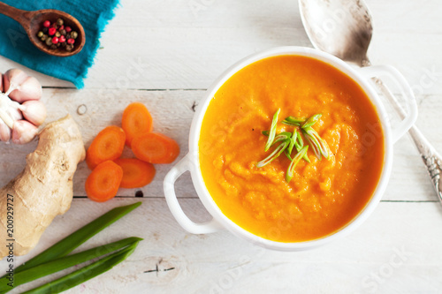 Carrot ginger cream soup with ingredients photo
