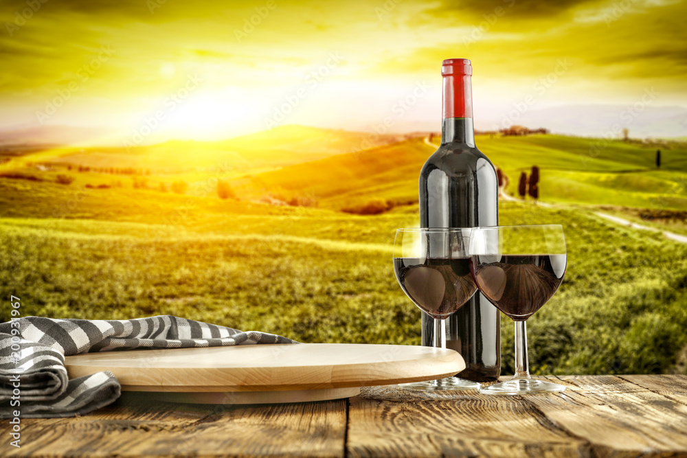 Wine on desk and Tuscany landscape 