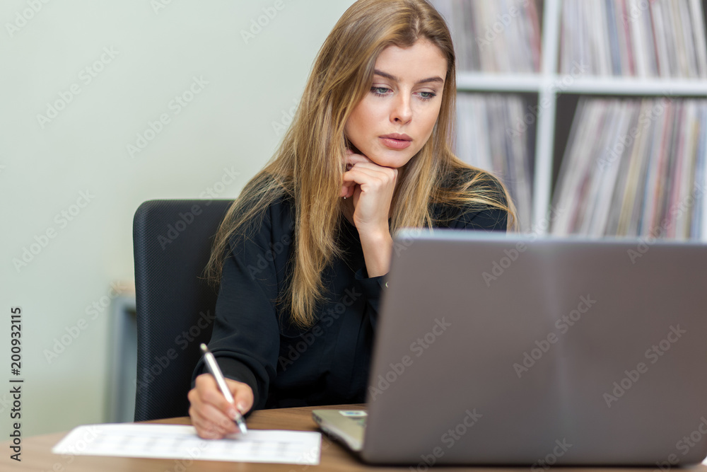 Happy young businessman using laptop at his office desk. Happy young businessman using laptop at his office desk.