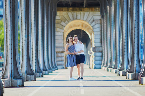 Couple walking along Bir-Hakeim bridge in Paris, France