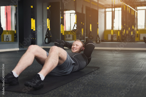 Young man fitness workout, sit-up crunches for abs
