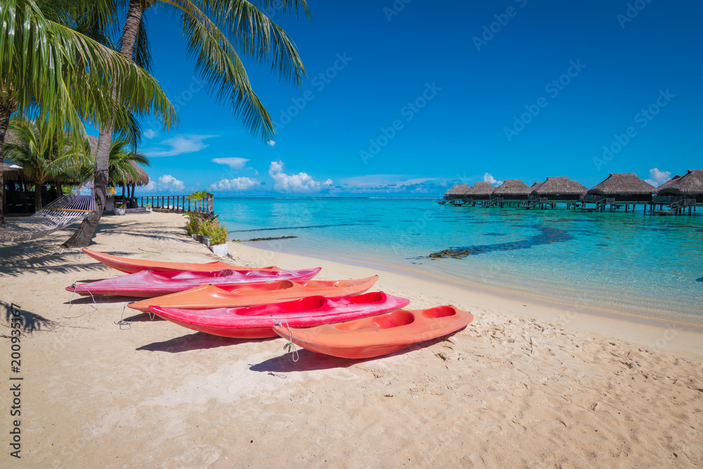 Canoes on the beach of tropical resort. Canoes on the beach of tropical resort.
