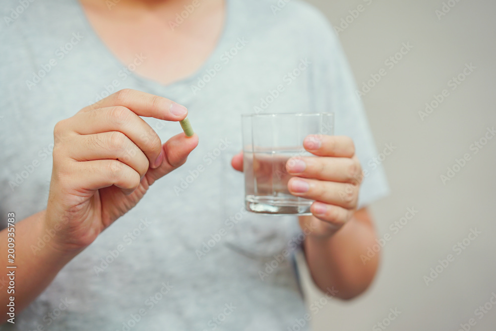 close up asian adult man holding medicine pills for healing disease close up asian adult man holding medicine pills for healing disease