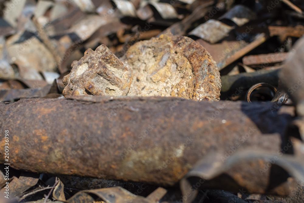 Rusty metal waste lying unsorted in a heap Rusty metal waste lying unsorted in a heap