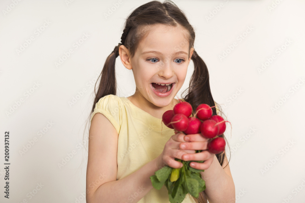 Happy little girl with radish over white background Happy little girl with radish over white background