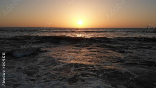 Flying over a beach at sunset