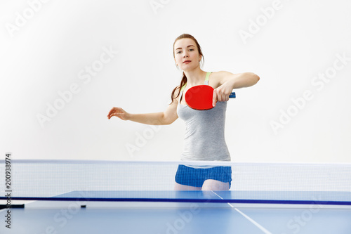 Sexy girl playing table tennis, isolated on white background © Aleksey Sergeychik