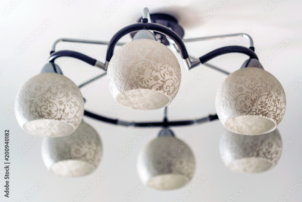 Modern white chandelier on the ceiling Modern white chandelier on the ceiling