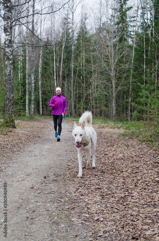 Woman with a dog on a run in the park Woman with a dog on a run in the park