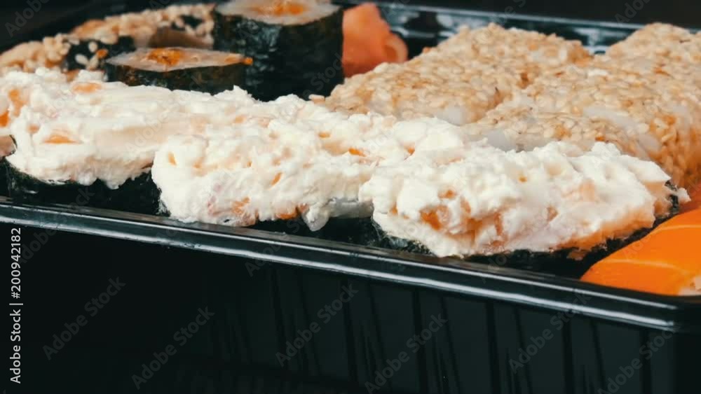 A lot of different Nigiri Gunkan Maki Sushi with eel salmon Philadelphia cheese cucumber close up view A lot of different Nigiri Gunkan Maki Sushi with eel salmon Philadelphia cheese cucumber close up view