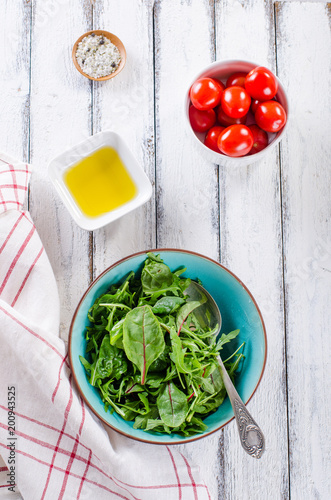 simple fresh salad ingredients on white wooden backround