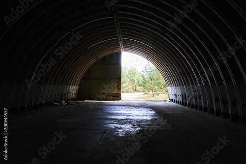  Interior of abandoned old military hangar for storage and maintenance of fighter jets and other military aircraft