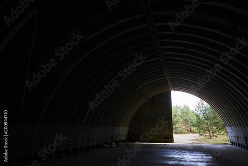  Interior of abandoned old military hangar for storage and maintenance of fighter jets and other military aircraft