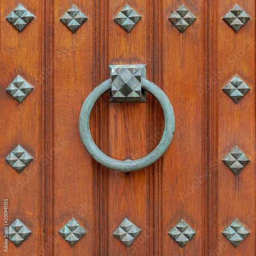 Doorknocker bronze ring on wooden door