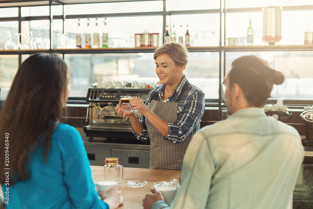 Experienced smiling barista giving master class Experienced smiling barista giving master class