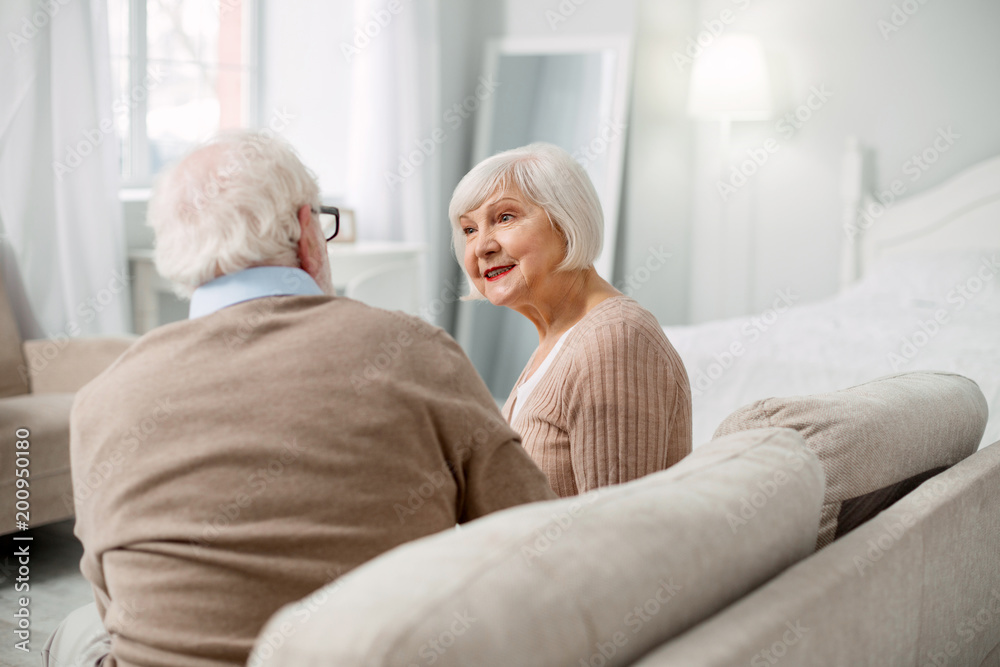 At home. Nice aged couple spending time together while being at home At home. Nice aged couple spending time together while being at home
