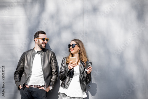 Stylish couple on the grey background
