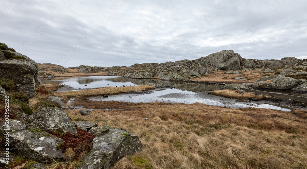 Fototapeta premium Beautiful landscape with a pond in the Rovaer island in Rovaer archipelago in Haugesund, Norway.