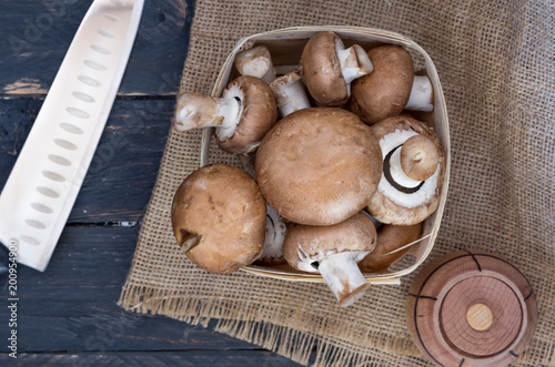 Basket with champignons. Kitchen knife. Knife chef.