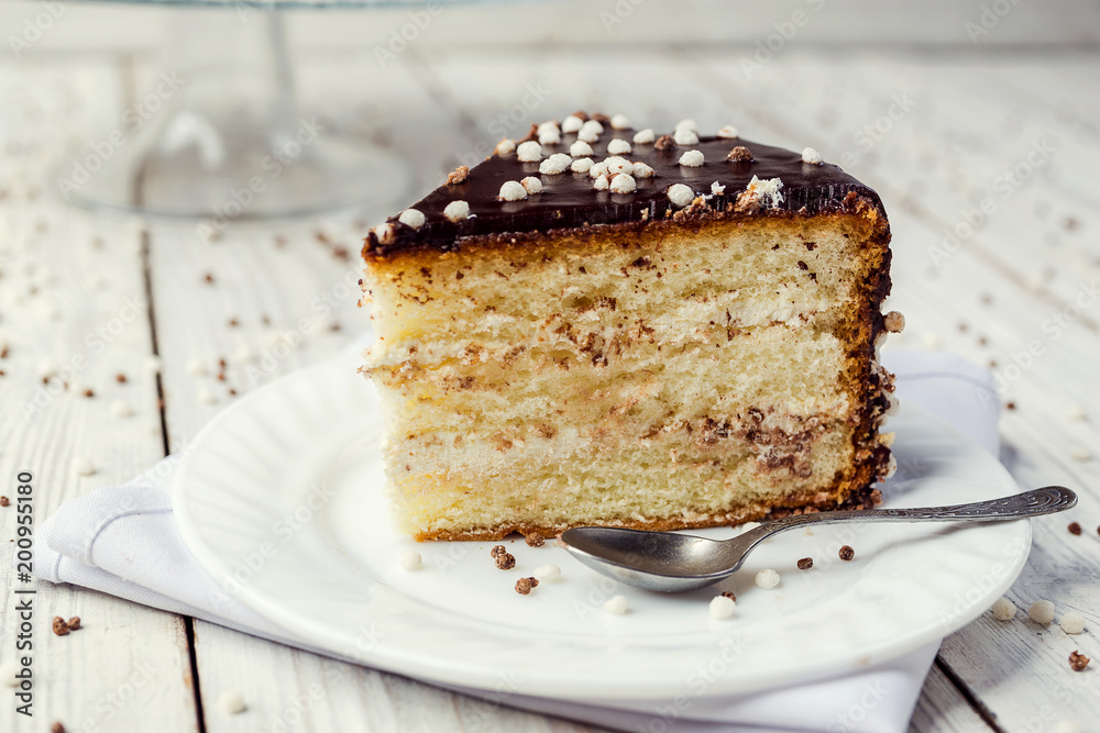 biscuit cake with caramel and chocolate on a wooden background biscuit cake with caramel and chocolate on a wooden background