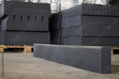 Concrete road curbs at the factory for the production of cement products, paving slabs, construction material for a new sidewalk