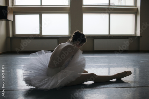 Young ballet dancer wearing pointe shoes in studio