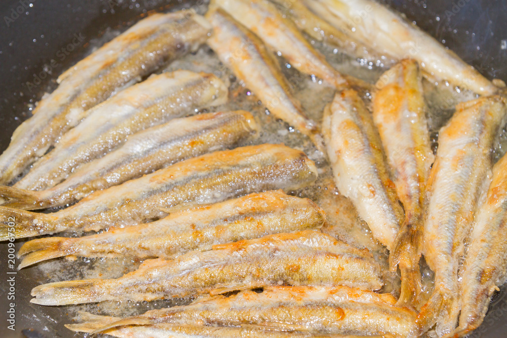 Cooking fried fish smelt rolled in flour