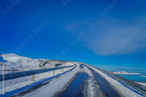 Gorgeous outdoor view of street covered with snow in Lofoten Islands in a sunny day