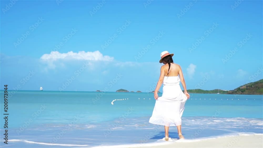 Young fashion woman in hat on the beach Young fashion woman in hat on the beach