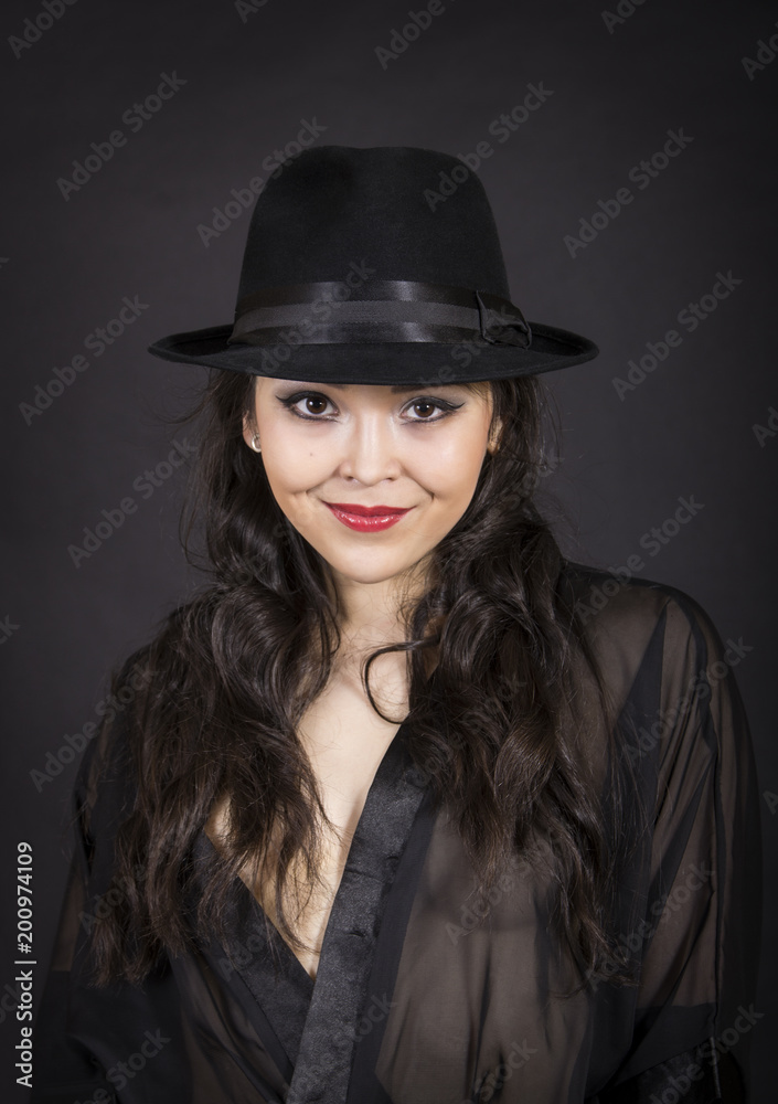 Beautiful young girl in black tunic, black gloves and black hat. Beautiful young girl in black tunic, black gloves and black hat.