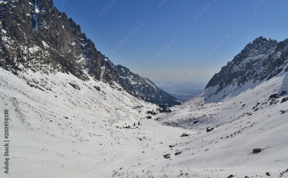 Snowy valley scenery in winter mountains