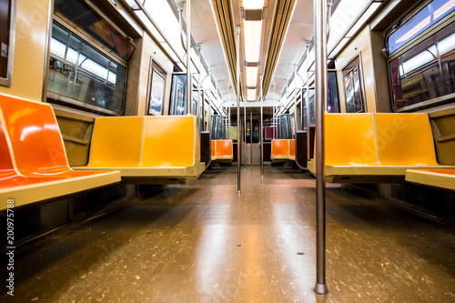 New York City subway car interior with colorful yellow and orange seats