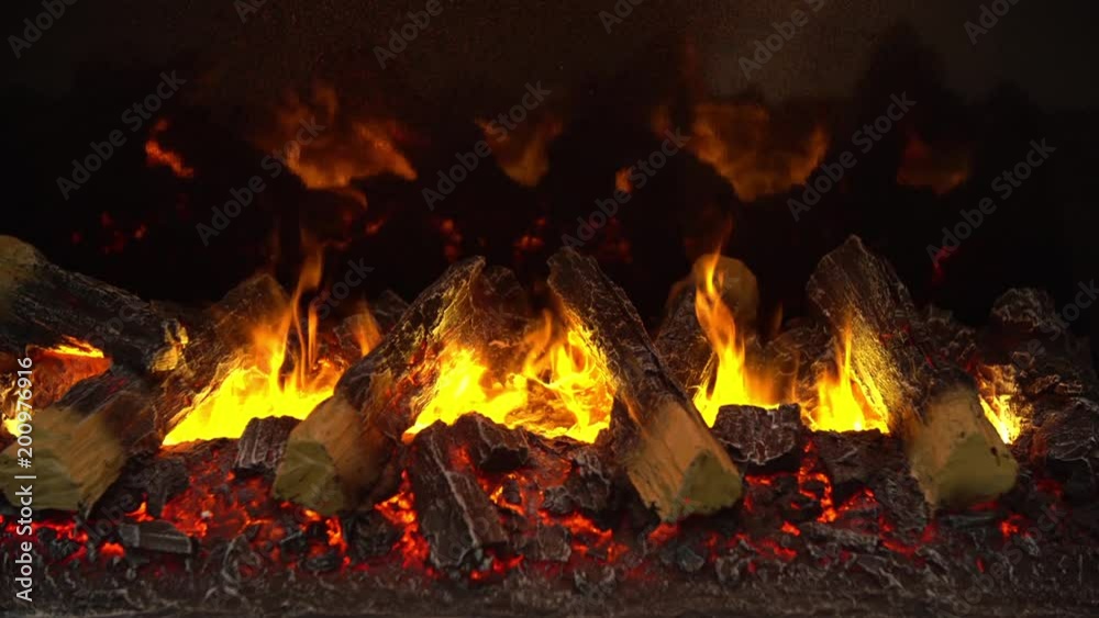 Fire burning in fireplace with woods close up view Fire burning in fireplace with woods close up view