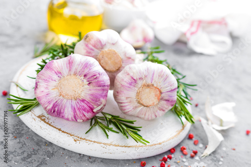 Garlic. Fresh garlic, oil and rosemary on kitchen table