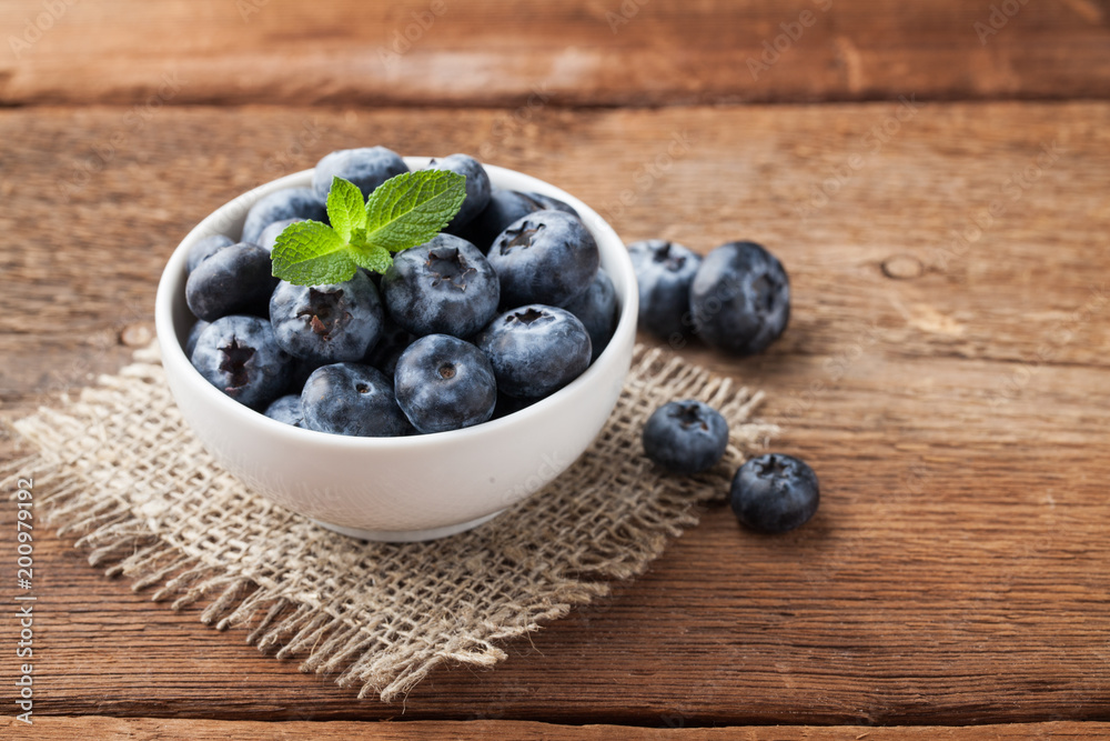 Blueberry on wooden table background. Ripe and juicy fresh picked blueberries closeup. Berries closeup with copy space Blueberry on wooden table background. Ripe and juicy fresh picked blueberries closeup. Berries closeup with copy space