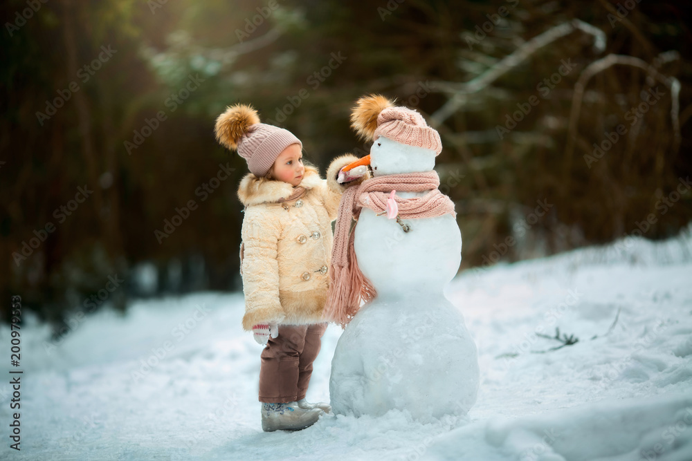 Little girl with snowman