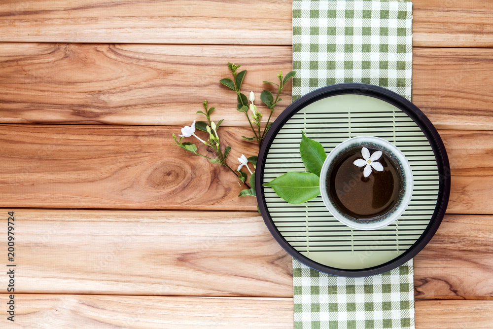 Φωτογραφία Top view or overhead shot of a cup of tea decoration on wooden background ,Japanese organic tea style concept