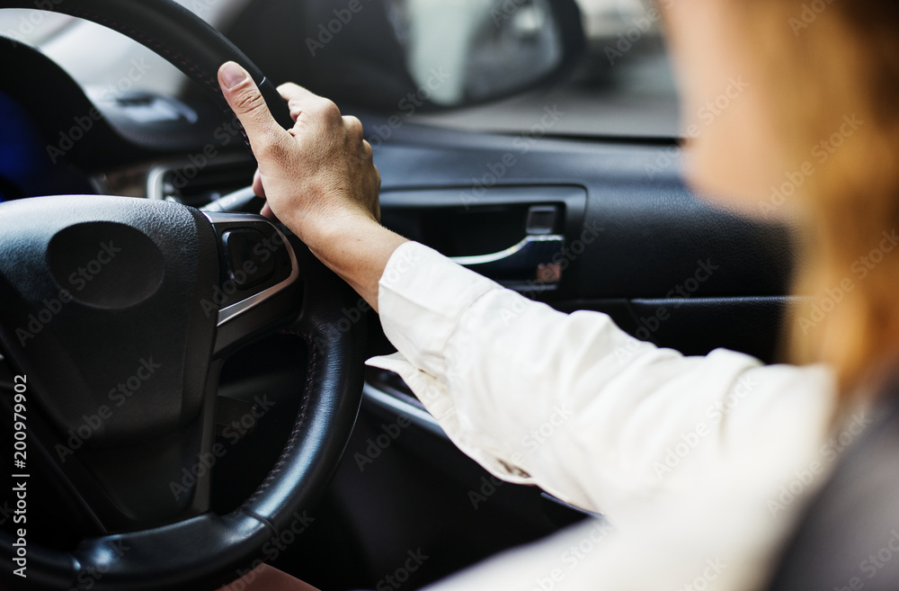 Woman driving a car on a road