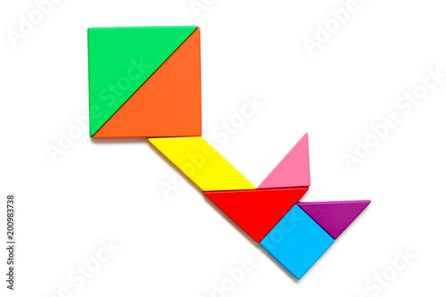 Color wood tangram puzzle in key shape on wood background