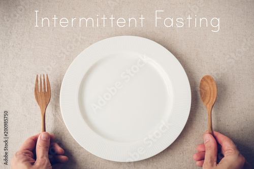 white plate with spoon and fork, Intermittent fasting concept, ketogenic diet, weight loss, diet