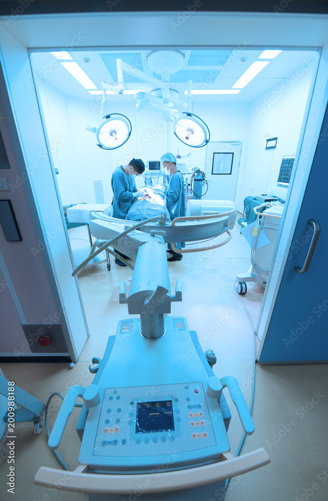 Two of veterinarian surgery in operation room take with art lighting and blue filter