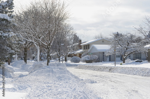 Heavy winter snow fall in Canadian residential area - snow covered streets on a bright sunny day